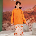 smiling girl posing wearing orange mandarin collar kurung top