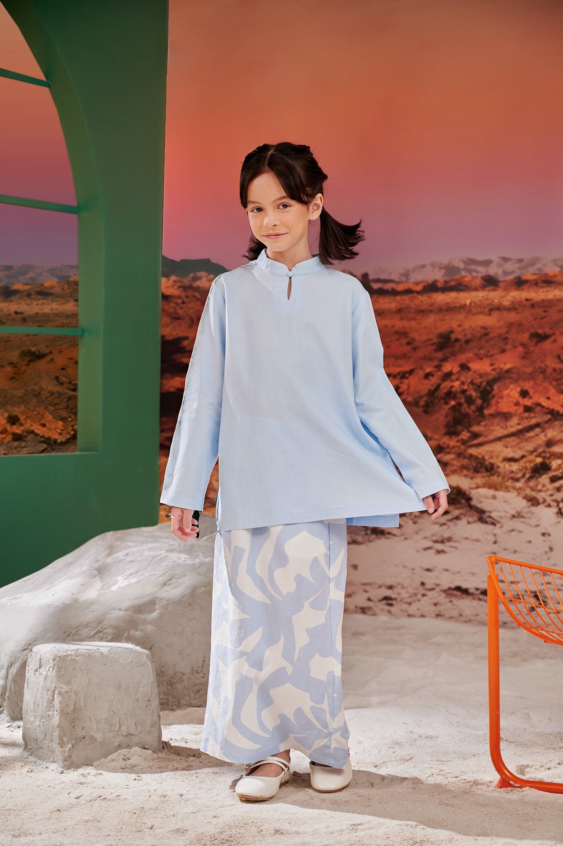 young girl posing in mandarin collar kurung sky blue