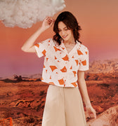 close shot of woman in desert print casual blouse