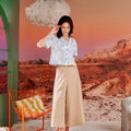 woman looking down posing wearing casual blouse mirage print