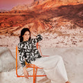 sitting woman wearing white classic skirt and posing