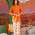 woman in desert print classic skirt scallop embroidery posing with clasped hands