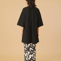 woman wearing shadow print classic skirt with scallop embroidery posing backwards