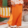 close shot of orange column skirt with back pleats