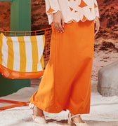 close shot of orange column skirt with back pleats