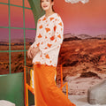 cheerful woman donning column skirt with back pleats orange