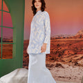 woman in column skirt with back pleats sky blue posing sideways