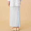 woman wearing column skirt with back pleats sky blue close shot