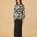 woman standing posing in shadow print kurung top with scallop embroidery