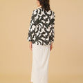 back view of woman in shadow print kurung top with scallop embroidery