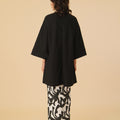 back view of woman donning long kurung blouse black