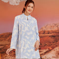 close shot of woman in mirage print mandarin collar kurung top