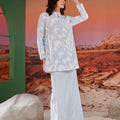 pretty woman posing with hand wearing mirage print mandarin collar kurung top