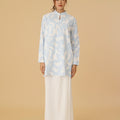 woman donning mandarin collar kurung top mirage print