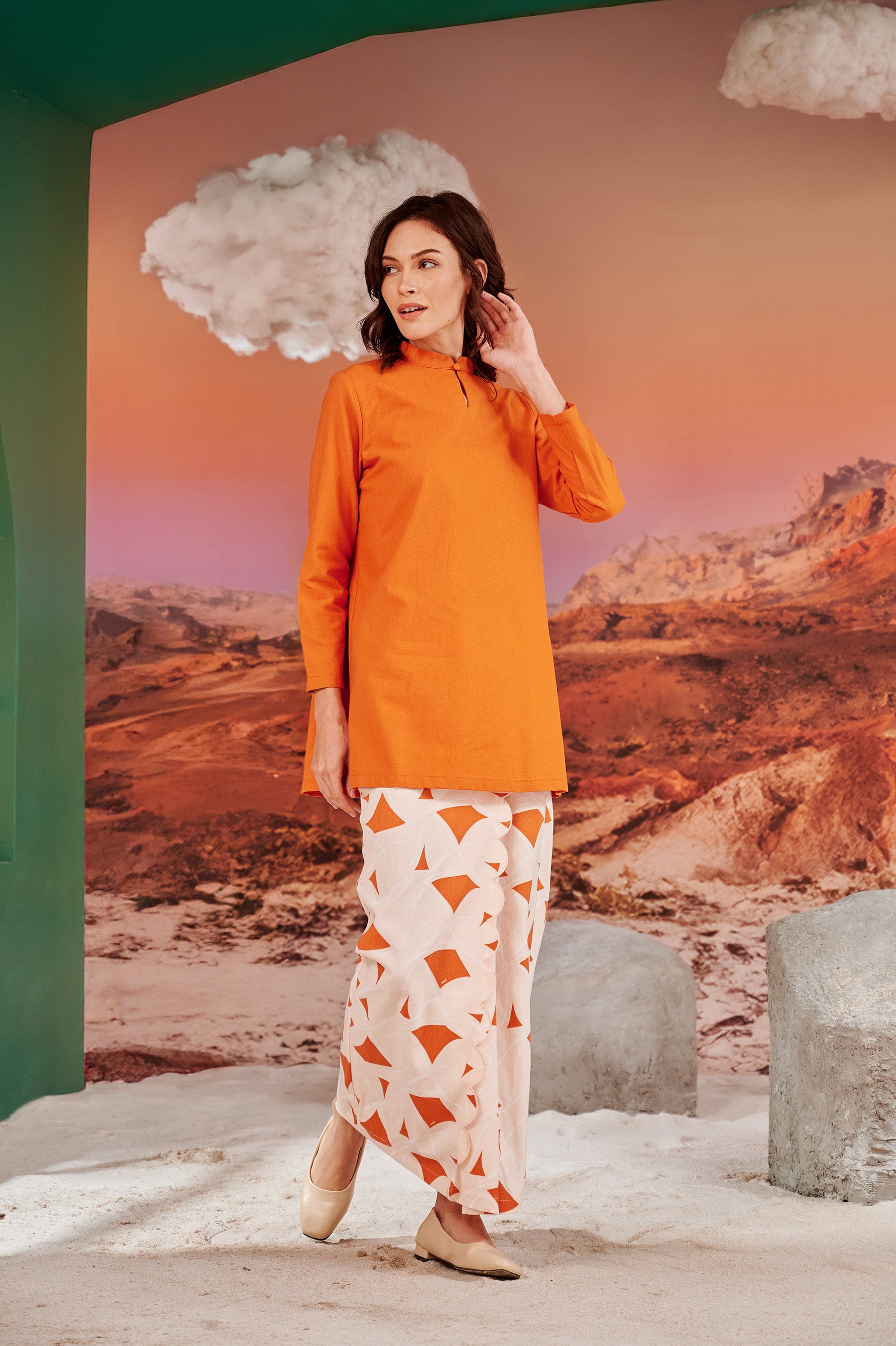 woman posing in mandarin collar kurung top orange