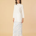 woman side view wearing white mandarin collar kurung top