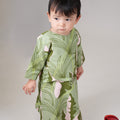 baby girl in estate print baby kurung dress posing for the camera