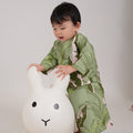 baby girl playing toys and donning baby kurung dress estate print