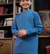 smiling boy with clasped hand posing, wearing steel blue boy baju melayu set