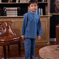 little boy posing in steel blue boy baju melayu set