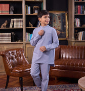 young boy holding placket, wearing stone blue boy baju melayu set