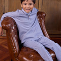 little boy sitting on chair wearing boy baju melayu set stone blue