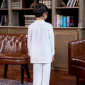 little boy posing backwards wearing boy baju melayu set white