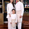 happy family donning the warisan raya white collection together