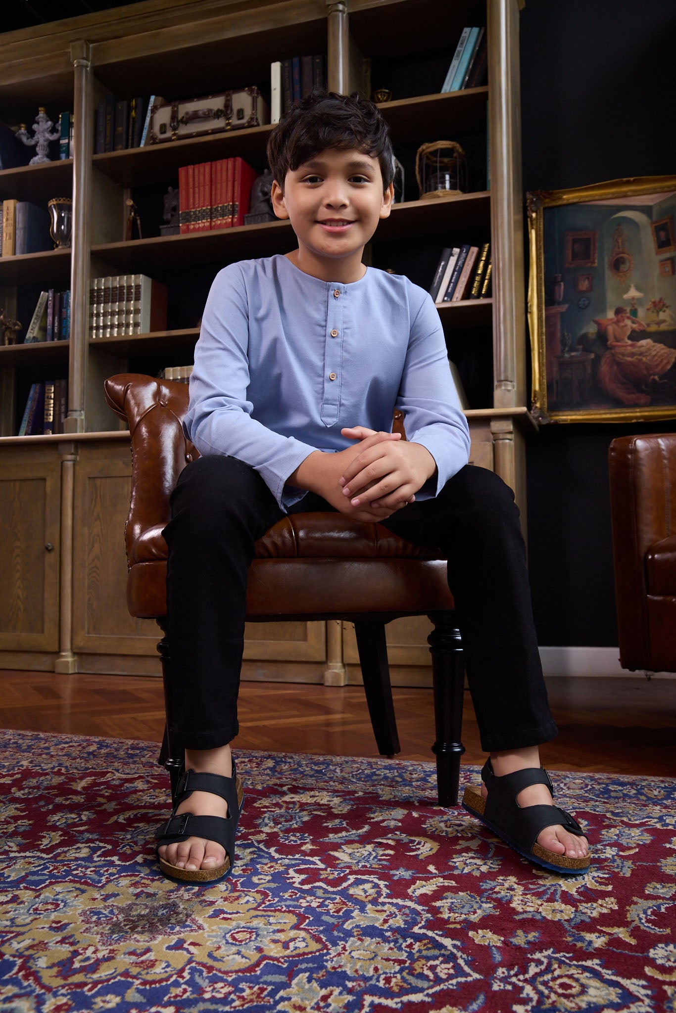 boy sitting on chair posing in stone blue boy kurta top