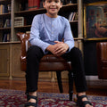 boy sitting on chair posing in stone blue boy kurta top