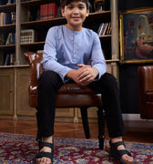 boy sitting on chair posing in stone blue boy kurta top