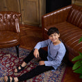 boy sitting and leaning to the chair wearing stone blue boy kurta top