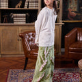 girl posing standing sideways donning estate print classic skirt