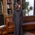 back view of girl wearing checked black girl fitted kurung set