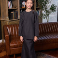 lovely girl smiling and posing in girl fitted kurung set checked black