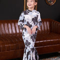 little girl posing prettily in bunga raya print jasmine kurung set