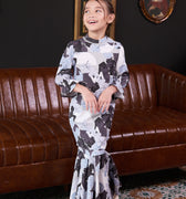 little girl posing prettily in bunga raya print jasmine kurung set