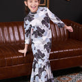 cheerful girl posing wearing bunga raya print jasmine kurung set