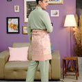 men in traditional attire sage green baju melayu set standing backwards  