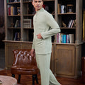 man posing standing sideways donning sage green baju melayu set