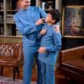 men and boy in steel blue baju melayu set smile in front of camera