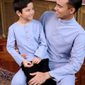 men and boy sitting, posing together in baju melayu set stone blue