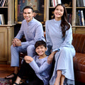 A family gathers for a portrait, wearing the warisan raya stone blue colour attire