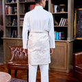 man standing backwards posing in white baju melayu set