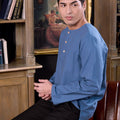 man wearing steel blue kurta top seated and posing for the camera