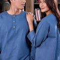 a close-up of man and woman matching in steel blue colour attire from warisan raya collection
