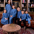 happy family posing together in matching steel blue colour attire