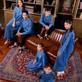 whole family dressed matching in steel blue colour, poses for the camera together
