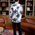 man stands backward posing in bunga raya print teluk belanga top