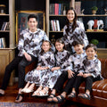 big family posing for the camera, wearing warisan raya bunga raya print clothes